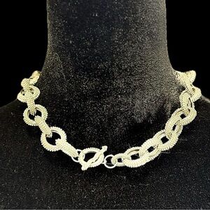 Edgy, statement, silver-tone textured link necklace with a bold toggle clasp